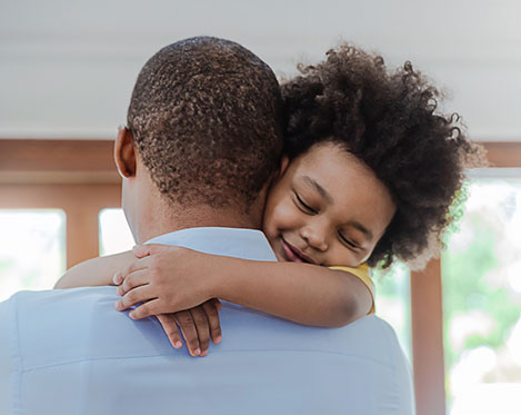 Child hugging father