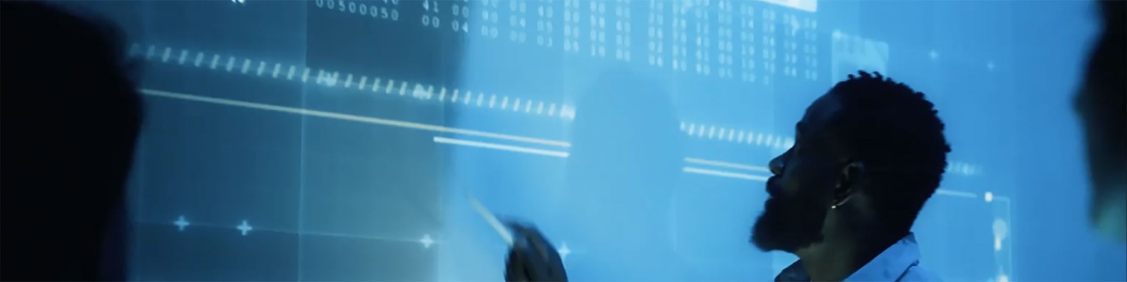 Man pointing at data on a transparent screen