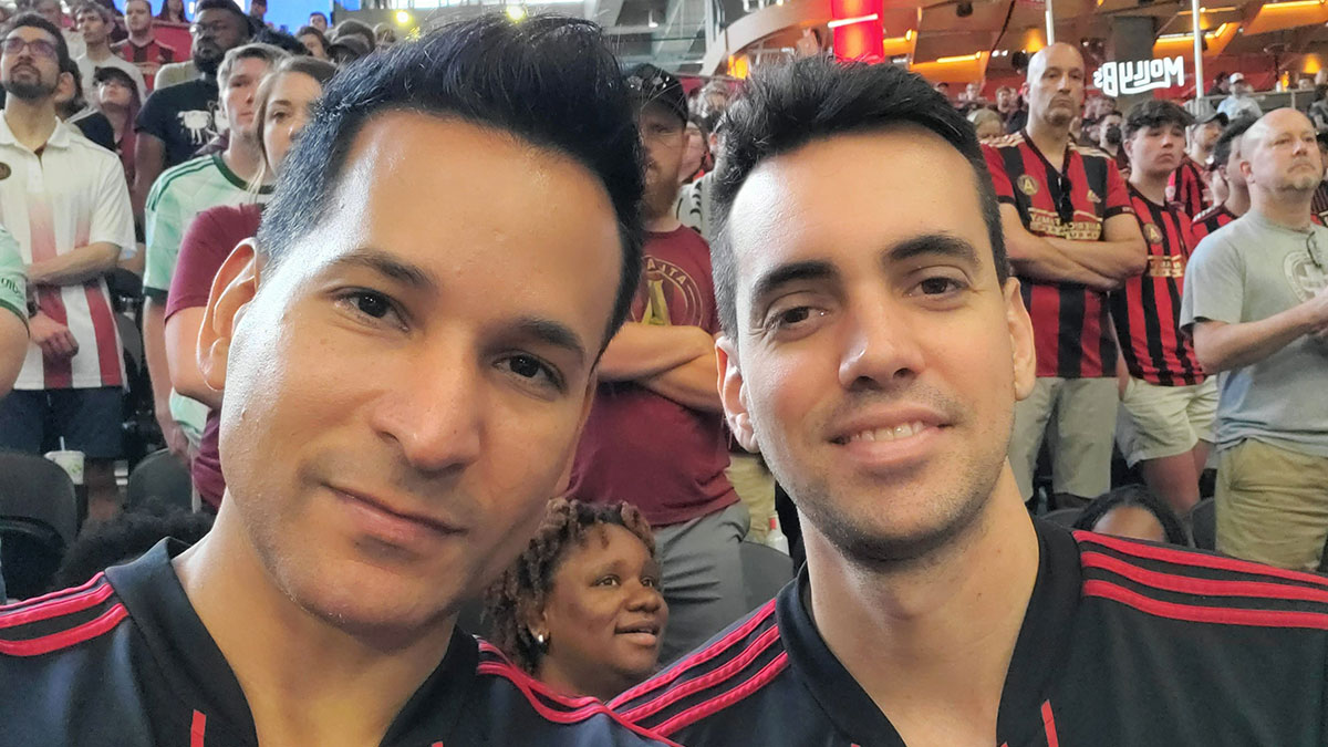 Carlos at ATL United game with partner Leo