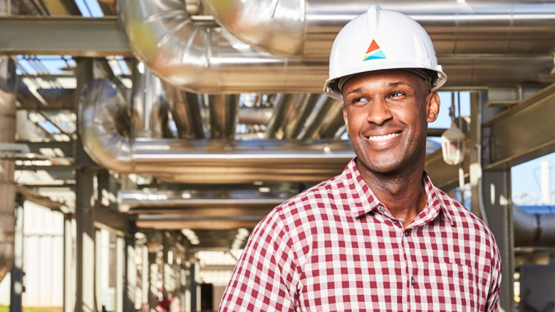 Man smiling in hard hat with Southern Company logo at power plant