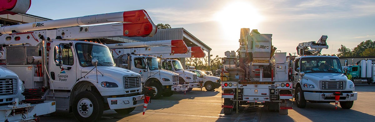 Several bucket trucks lined up and ready to restore power to communities