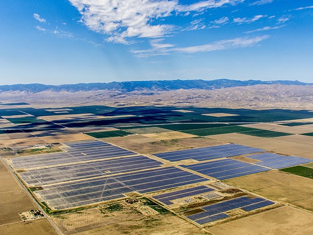 Tranquillity Solar Facility ariel in the desert with mountain range in the distance